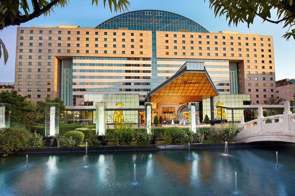 Stunning external view of Kempinski Hotel Beijing with elegant garden and pond.