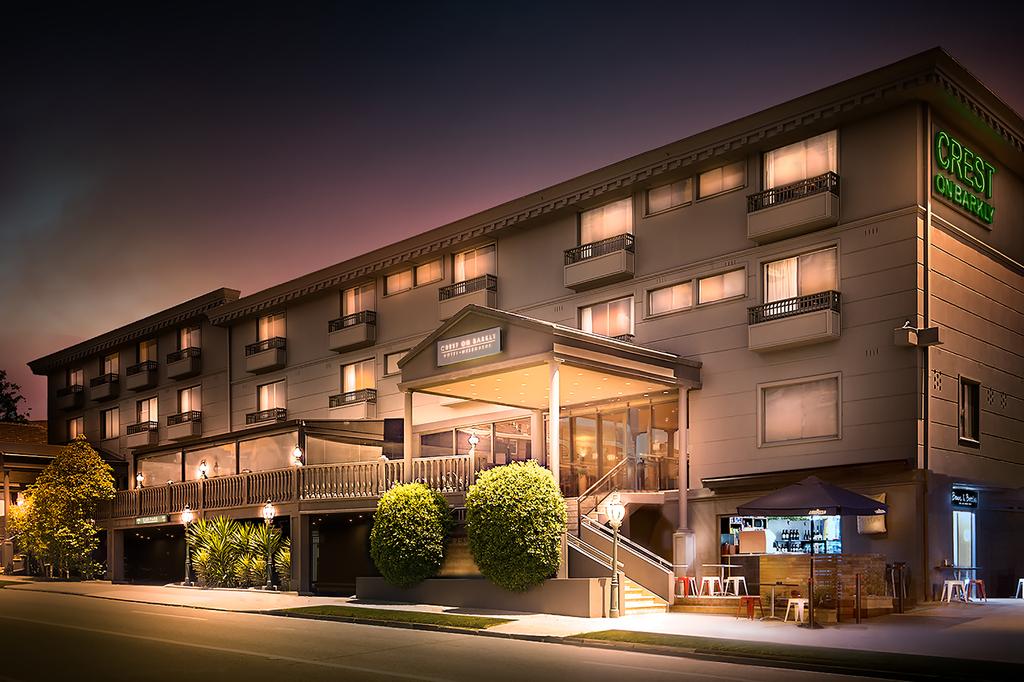 The Crest on Barkly Hotel Melbourne illuminated at night. 