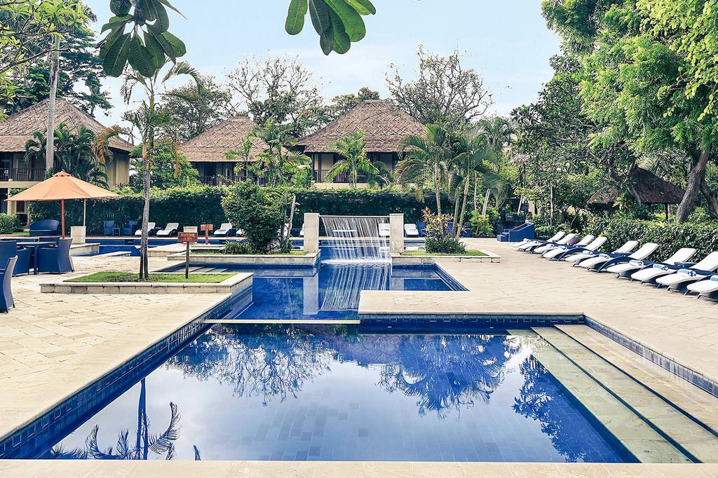 Luxurious Bali resort with two pools and tropical gardens.