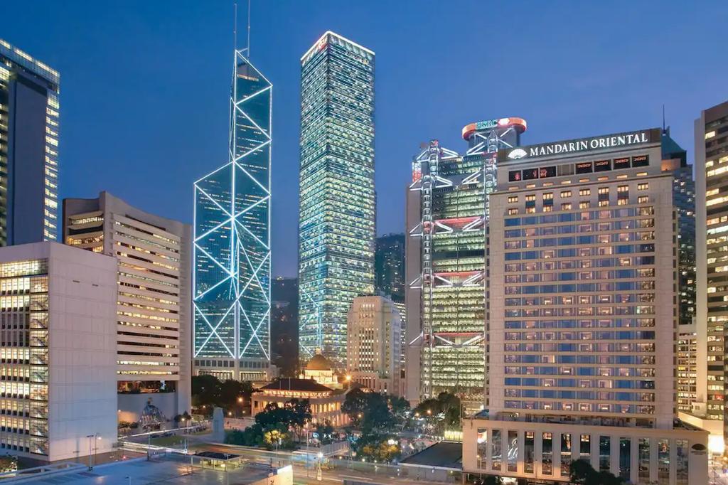 Skyline view of Mandarin Oriental, Hong Kong illuminated at night.