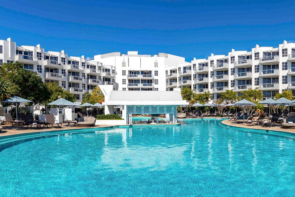 Lagoon-style pool at Sofitel Noosa Pacific Resort with poolside seating.