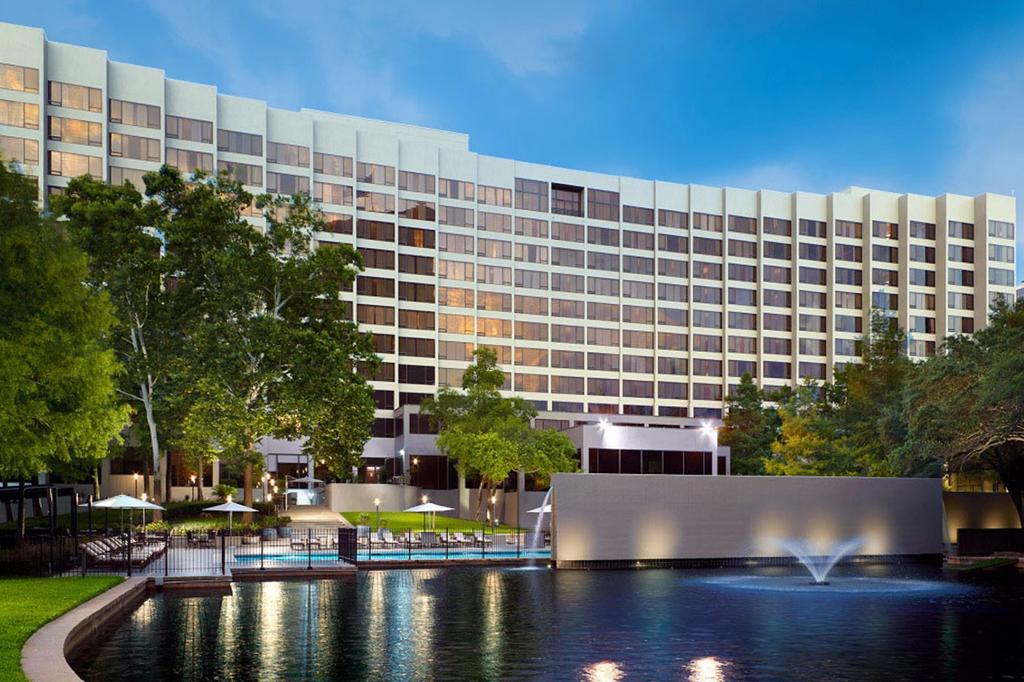 Contemporary Houston hotel with pool, trees, and a serene ambience.