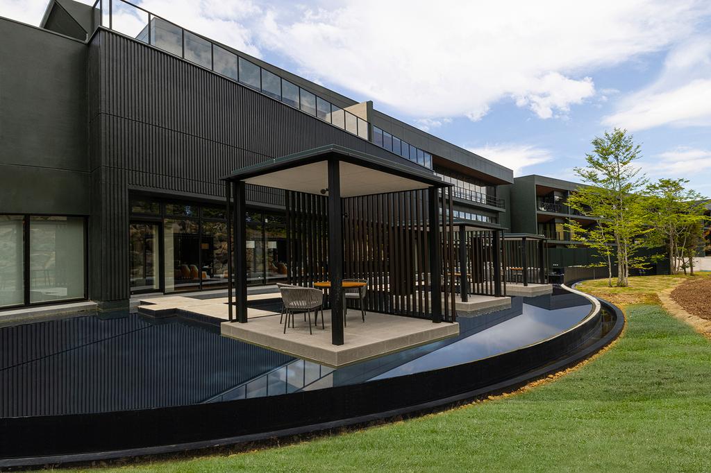 Modern architecture of ANA InterContinental Appi Kogen Resort in a lush setting.