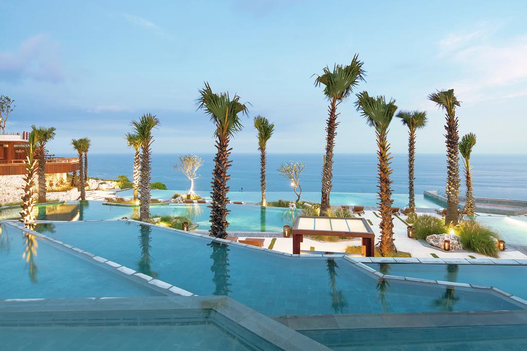 Infinity pools overlooking the ocean at a luxurious clifftop resort in Bali.