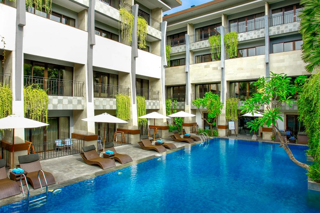 Stylish Bali hotel with a pool and sun loungers near Legian Beach.