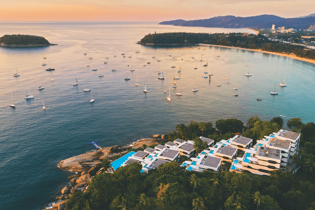 Aerial view of luxury clifftop resort overlooking Kata Beach in Phuket.