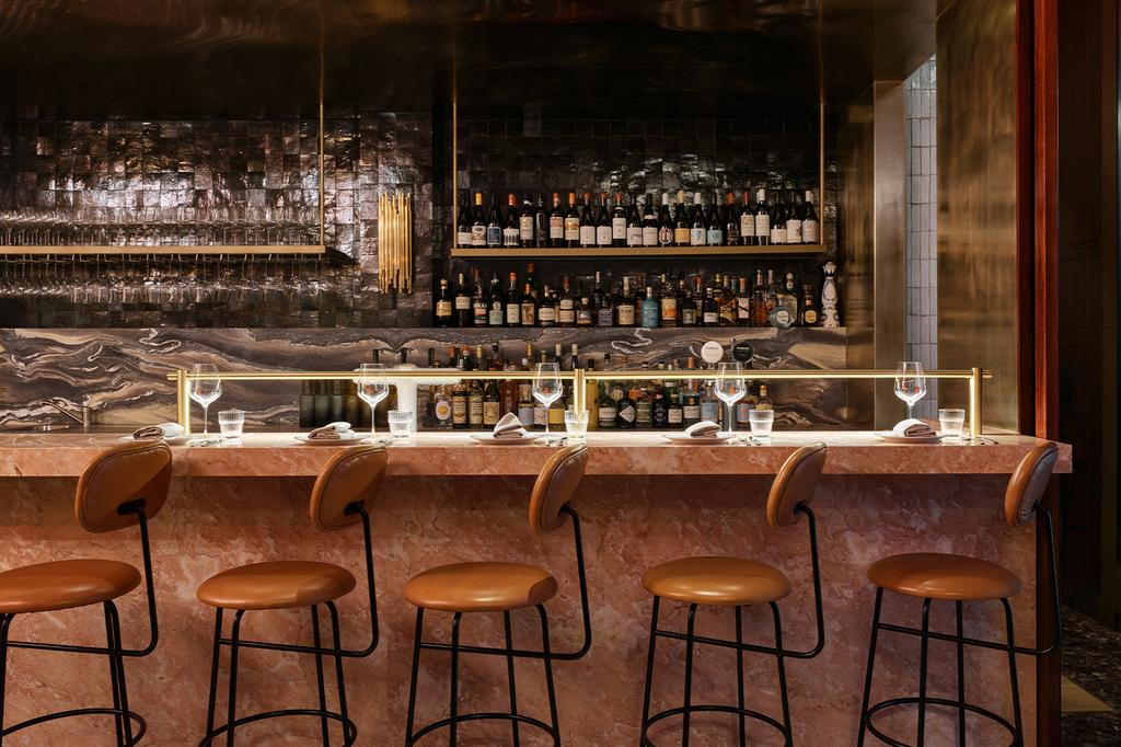 Chic wine bar interior with stylish seating and elegant decor.