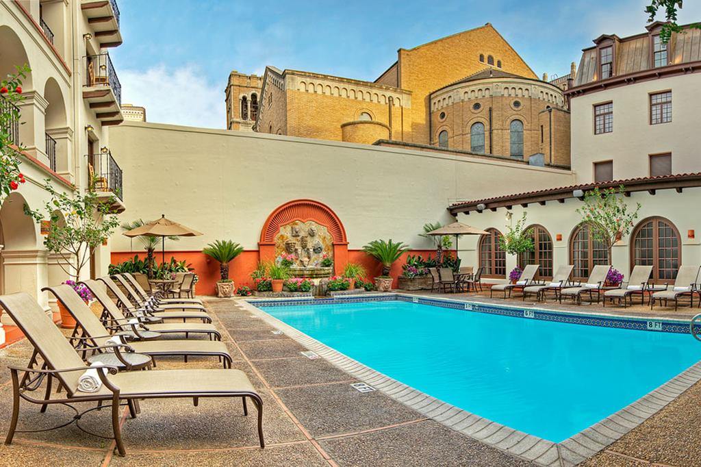 Courtyard pool area of a Spanish-style hotel in San Antonio.