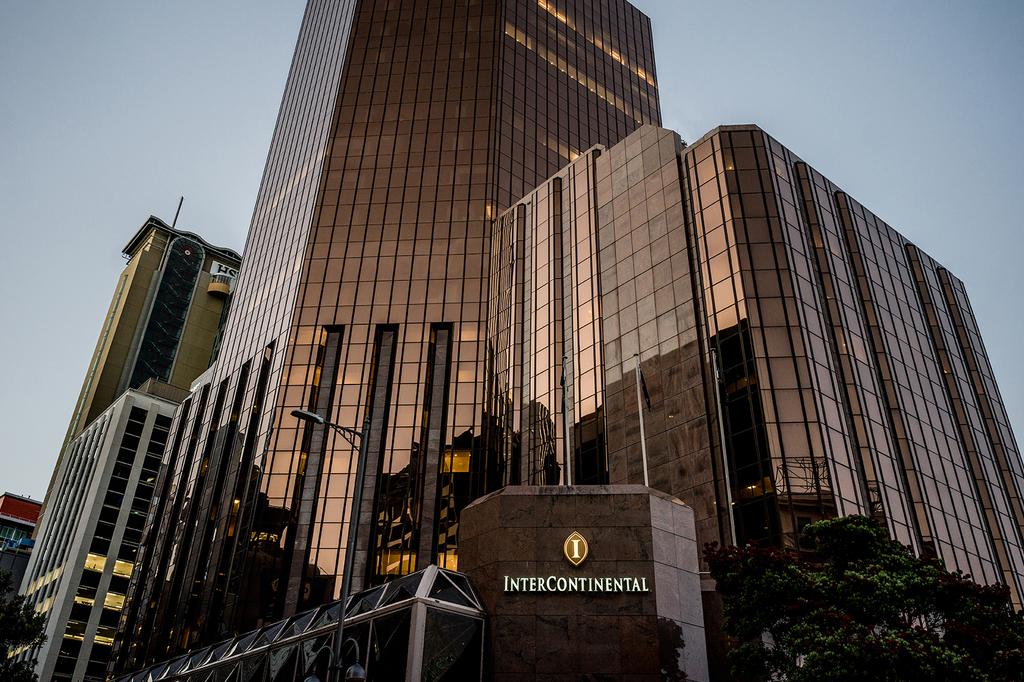 Facade of InterContinental Wellington hotel with a modern glass exterior.