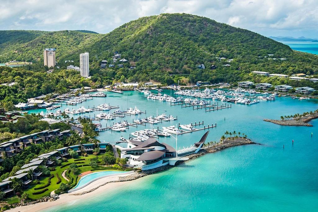 Aerial view of Hamilton Island resort overlooking turquoise waters and lush greenery.