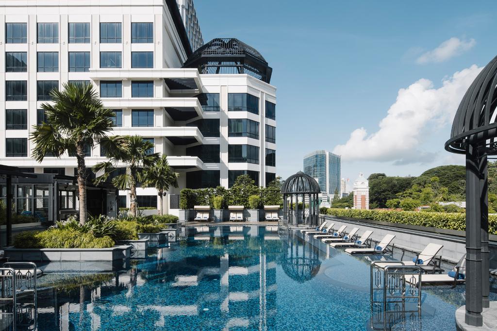 Grand Park City Hall rooftop pool with sun loungers in Singapore’s Civic District.