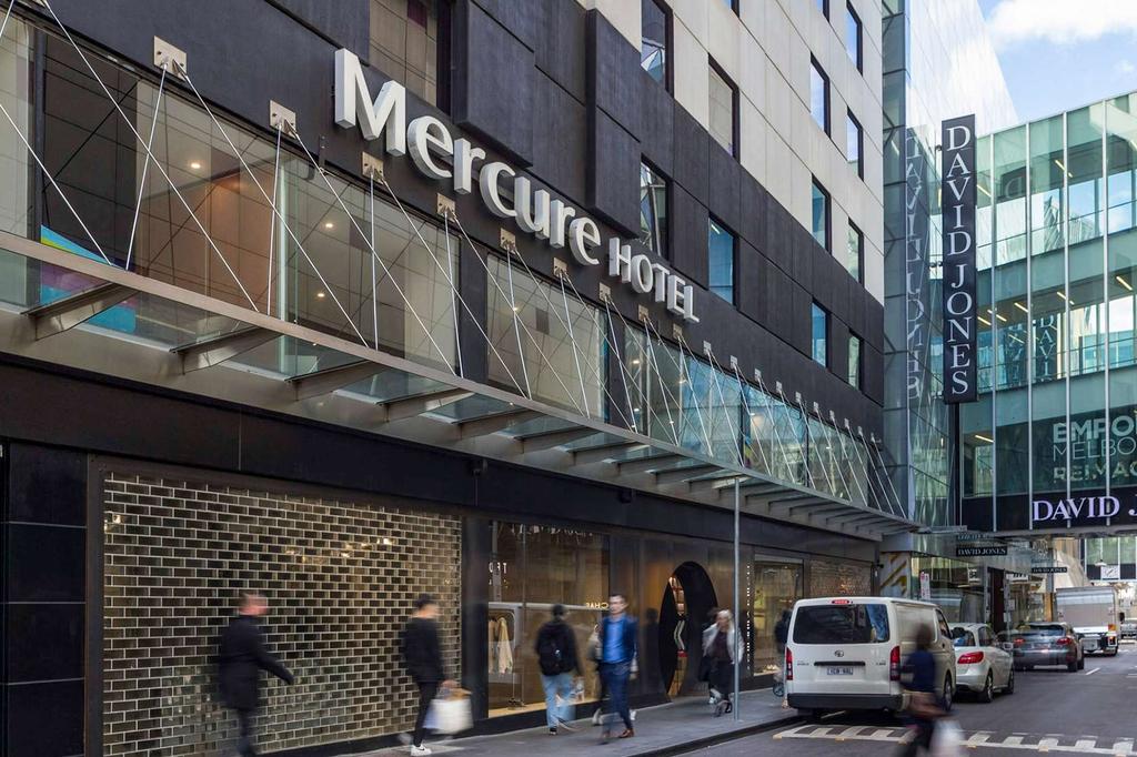 Exterior of Mercure Hotel Melbourne CBD on a busy street.