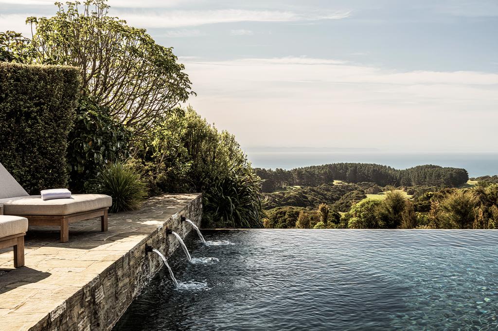 Infinity pool with views of Hawke's Bay countryside and Pacific Ocean.