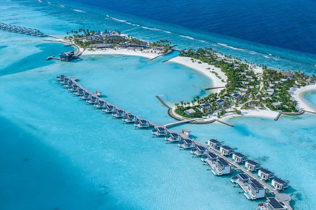 Aerial view of luxury overwater villas in the Maldives with turquoise waters.