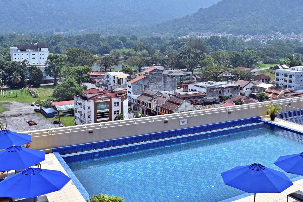 Rooftop pool with city and mountain views in Taiping, Malaysia.