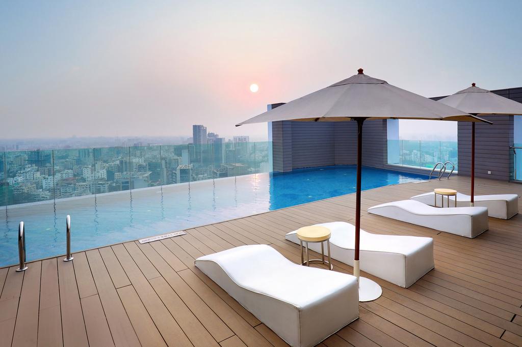 Rooftop infinity pool at Crowne Plaza Dhaka Gulshan with city views.