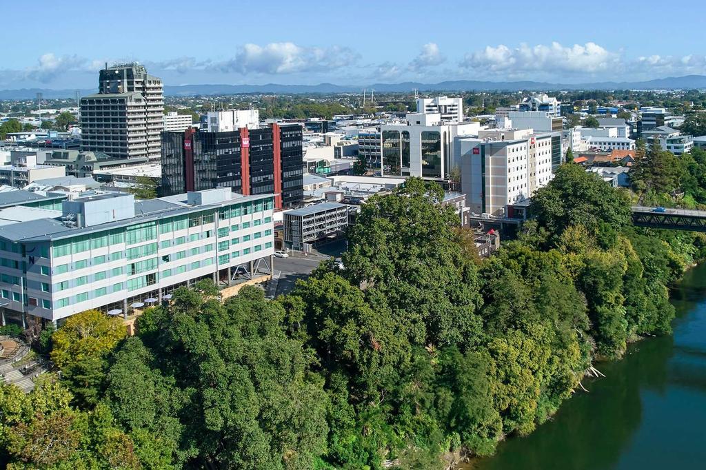 Hamilton cityscape with buildings along Waikato River.