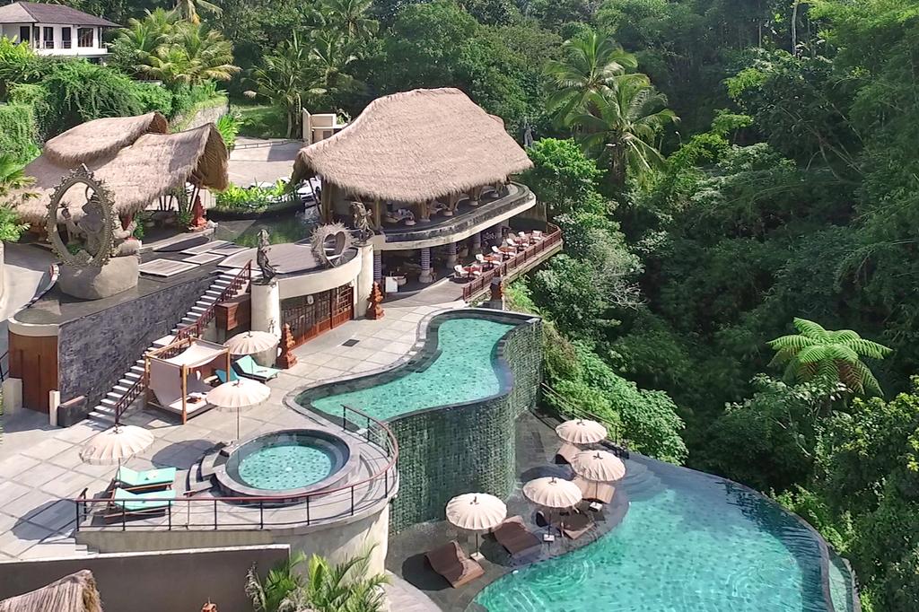 Infinity pool at a jungle resort in Ubud, Bali with scenic views.