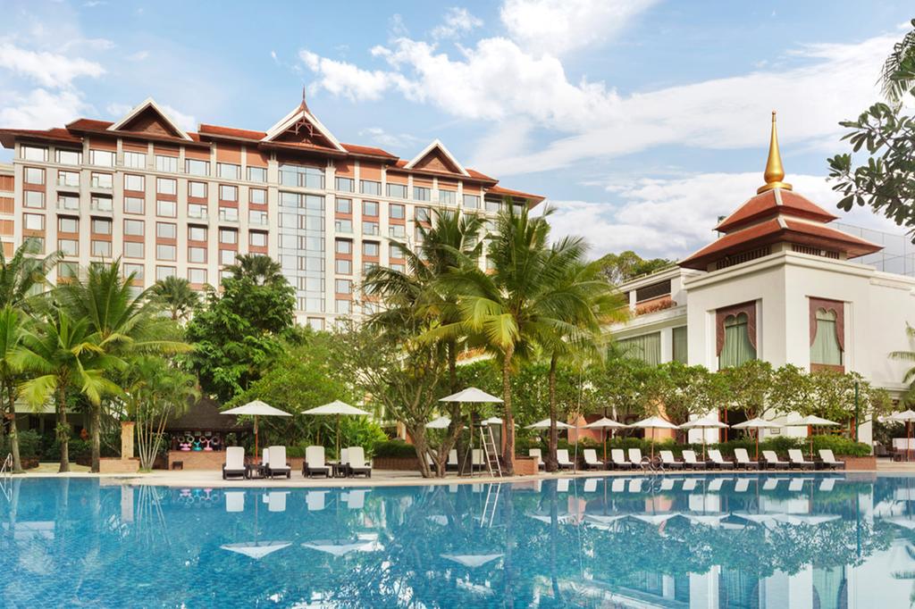 Luxury hotel with large pool and tropical foliage in Chiang Mai.