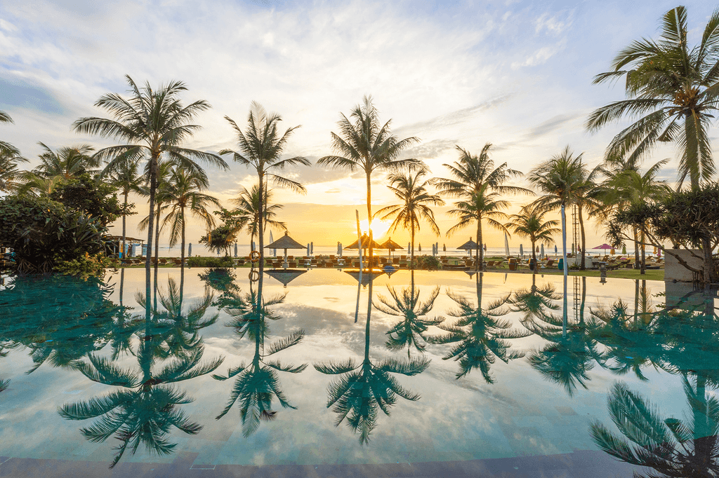 Sunrise view at the pool with palm trees at Ayodya Resort, Nusa Dua, Bali.  