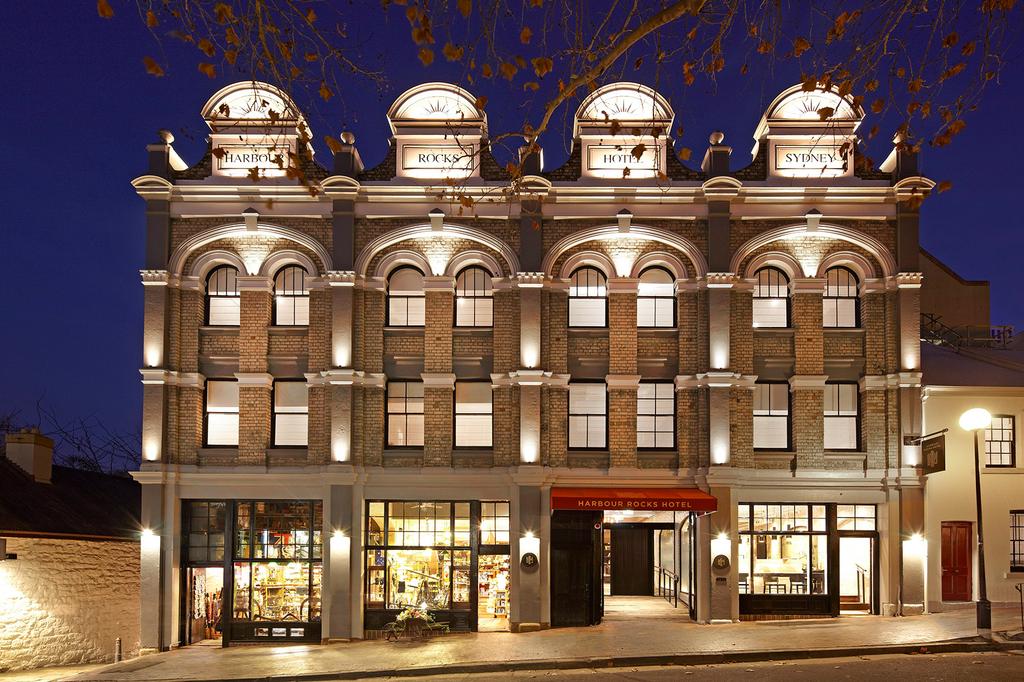 Facade of Harbour Rocks Hotel in Sydney's heritage district at night.