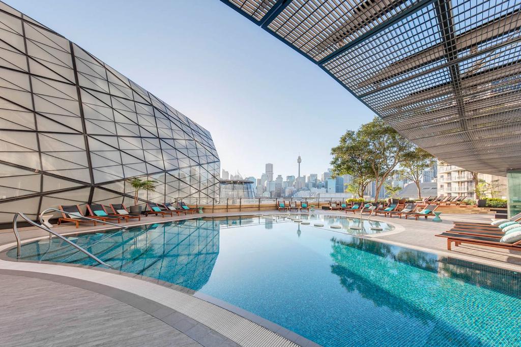 Luxurious hotel pool with cityscape views at The Star Grand Hotel in Sydney's harbourside.