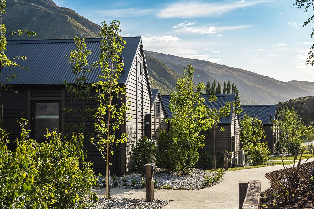 Charming villas set amid lush greenery and scenic mountains in Gibbston Valley.