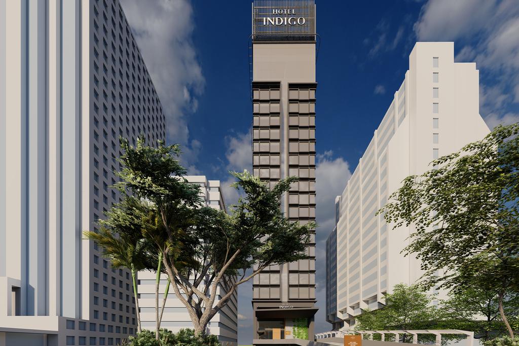 Hotel Indigo Kuala Lumpur with city skyline view.