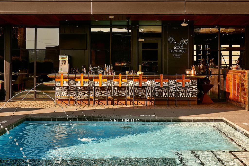Rooftop pool and bar area at a stylish Austin boutique hotel.