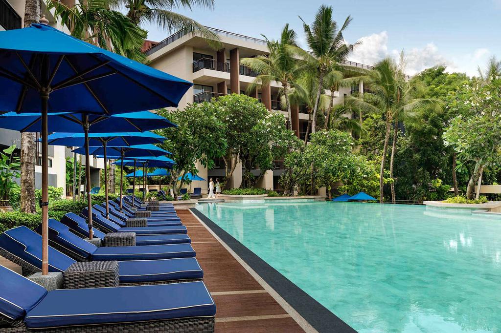 Sun loungers by the pool at Novotel Phuket near Kata Beach.