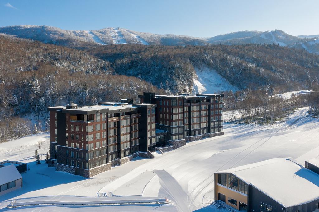 Ski-in, ski-out luxury suites at Yu Kiroro amid snowy mountains in Hokkaido. 