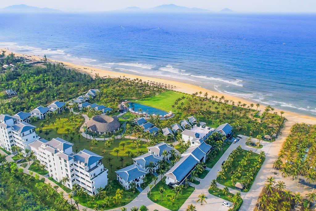 Aerial view of Bliss Hoi An Beach Resort by the scenic ocean.