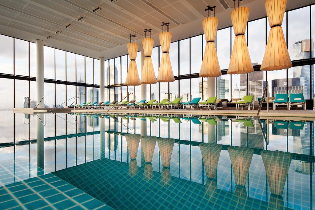 Sky-high indoor pool with panoramic views of Melbourne skyline.