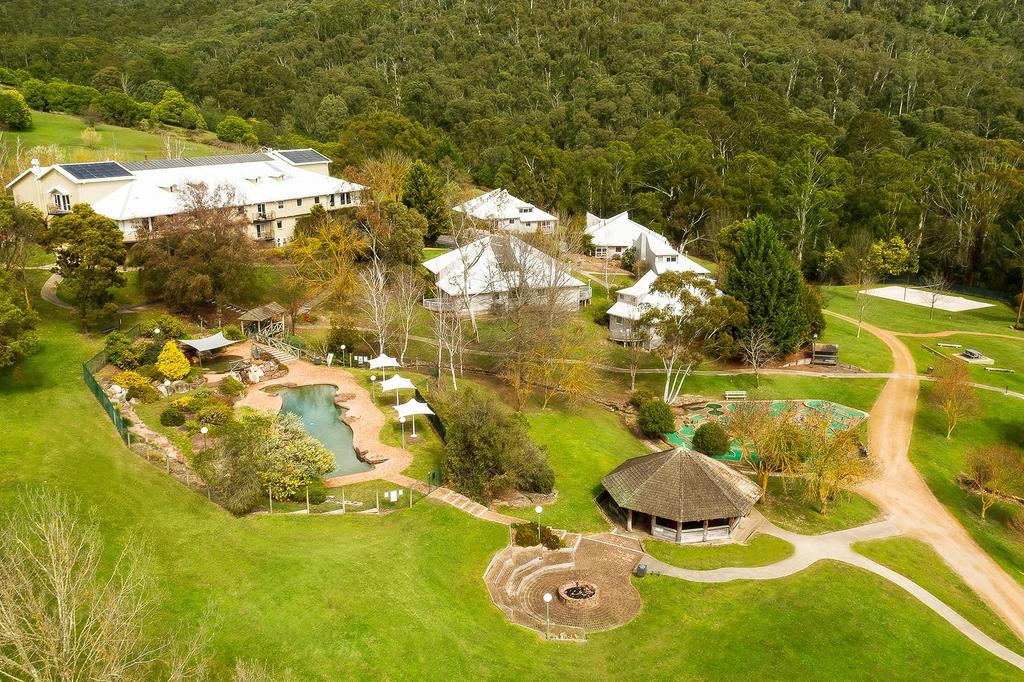 Aerial view of The Sebel Pinnacle Valley Resort surrounded by lush greenery.