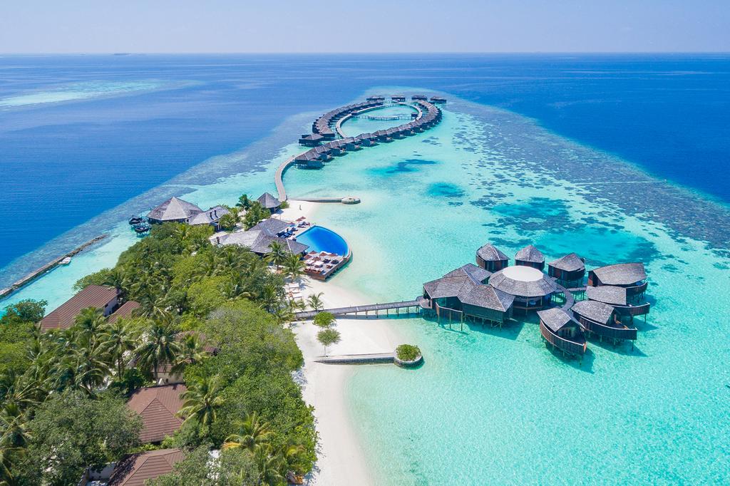 Aerial view of overwater villas and clear lagoon at Lily Beach Resort & Spa in the Maldives