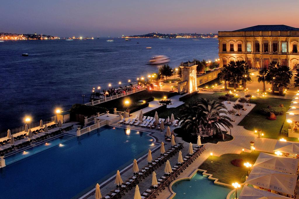 View of Çırağan Palace Kempinski Istanbul by the Bosphorus at dusk.