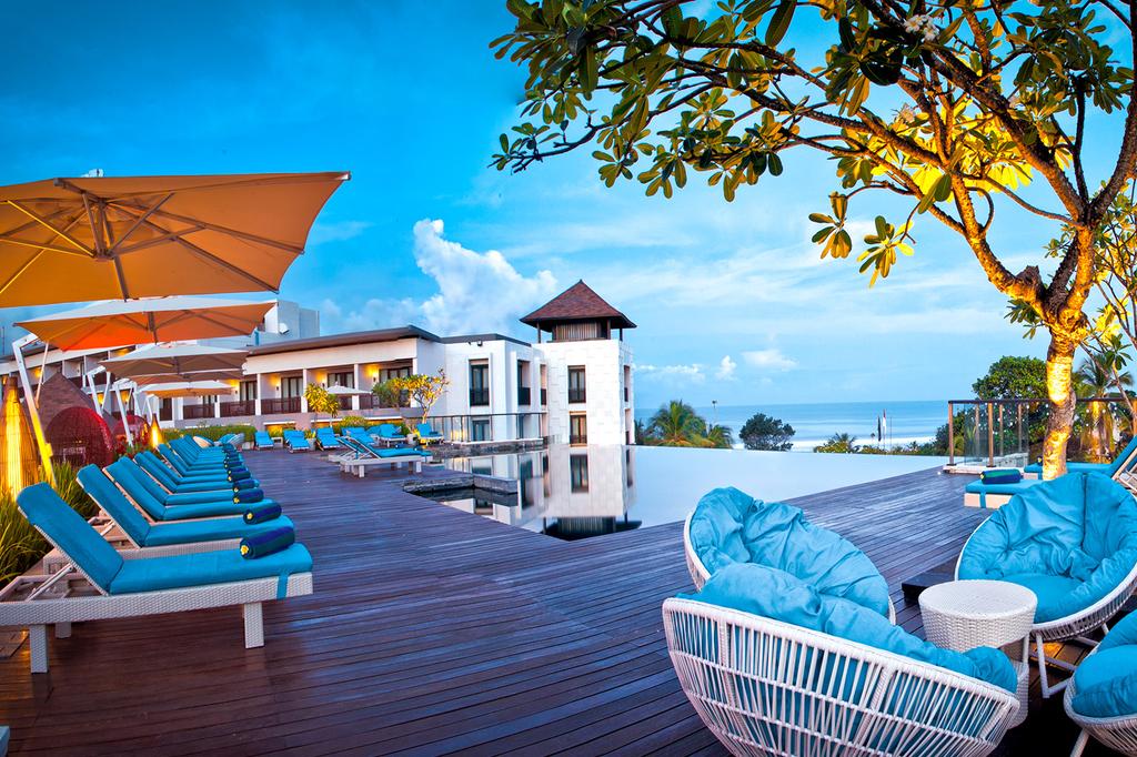 Luxurious deck with sun loungers overlooking the ocean at Pullman Bali.