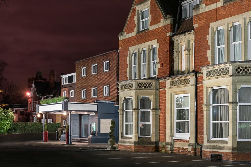 Elegant exterior of voco St John’s Solihull hotel at night.