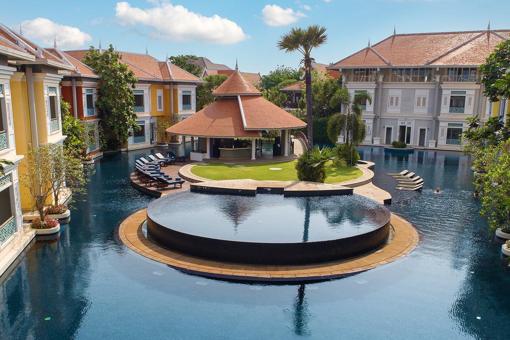 Luxury resort pool surrounded by traditional architecture in Siem Reap.