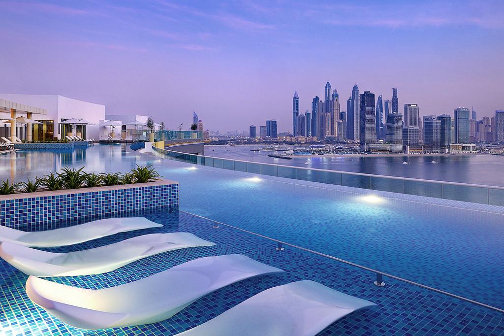 Evening view of the pool at NH Collection Dubai The Palm