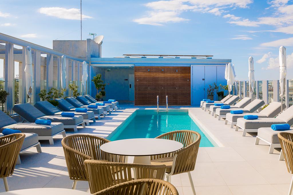 Rooftop pool area with sun loungers at Hotel Indigo Larnaca.