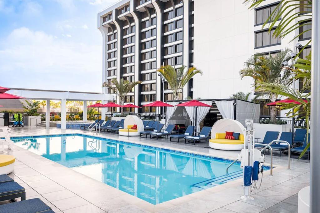 Rooftop pool at Pixar Place Hotel with lounge chairs and cabanas.