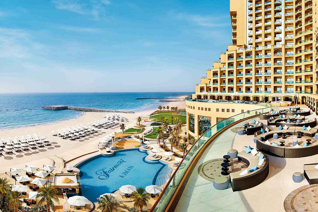 Luxurious beachfront hotel in Ajman with outdoor pool and sea views.