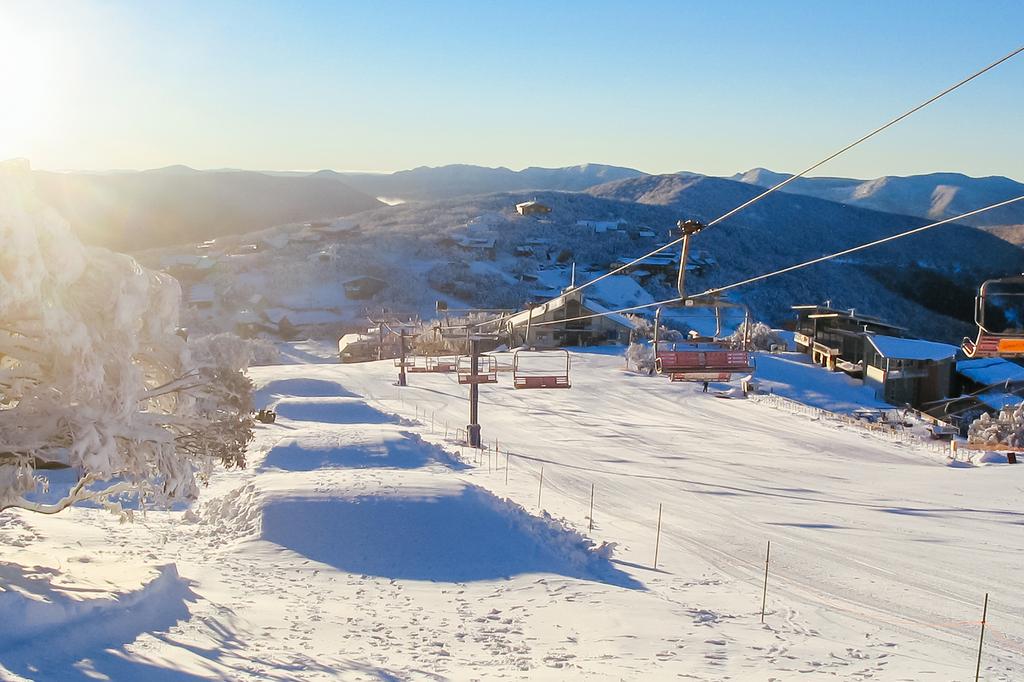 Ski lift and snowy slopes at Mount Buller ski resort.