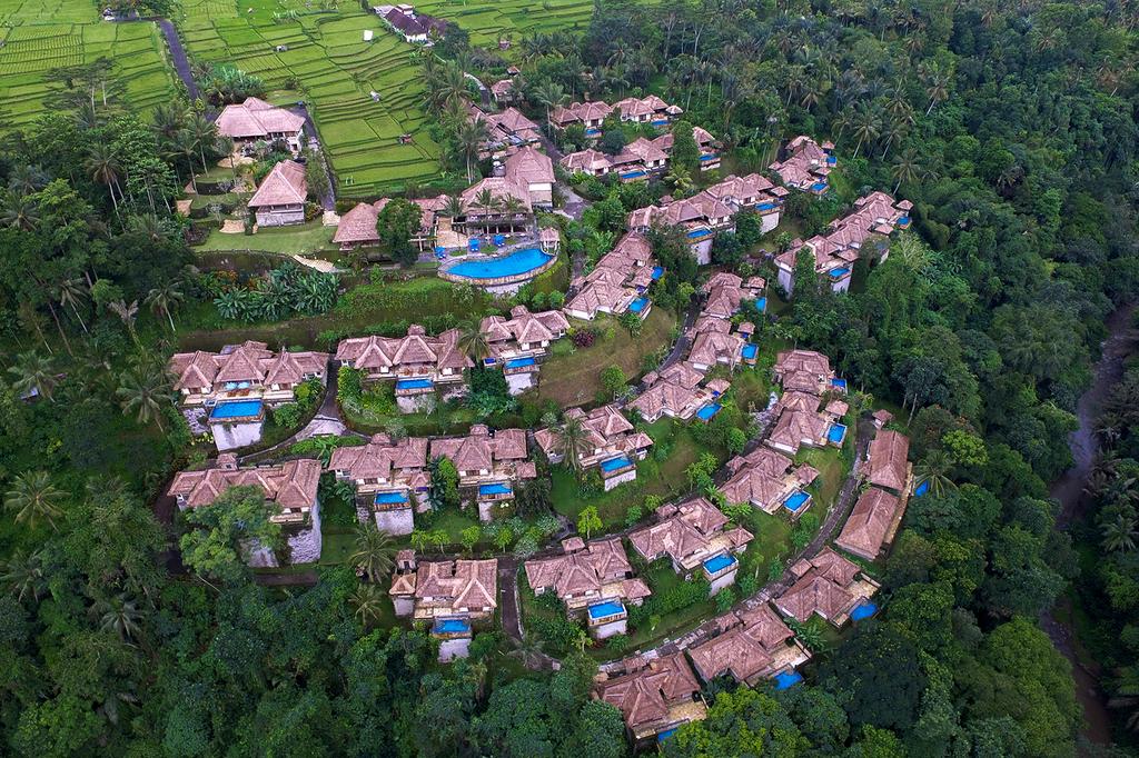 Aerial view of luxury villas amid lush jungle in Ubud, Bali.