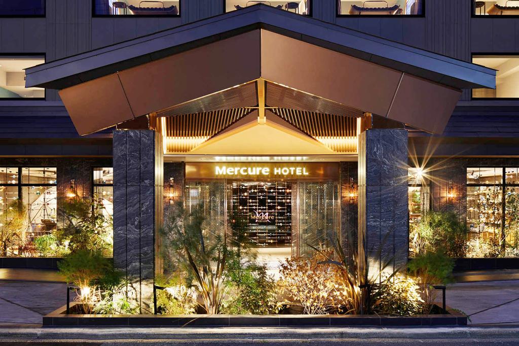 Entrance of Mercure Kyoto Station with modern design and garden.