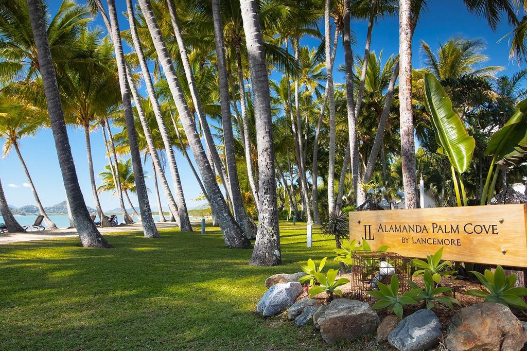 Palm-covered beachfront at Alamanda Palm Cove by Lancemore. 