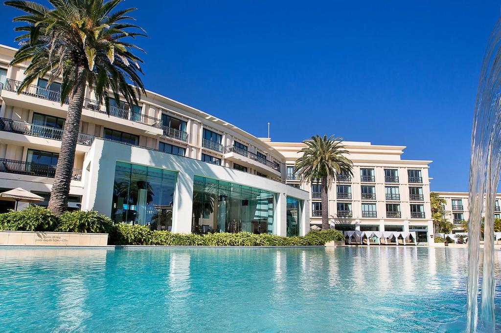 Luxury Imperial Hotel Gold Coast with a pool and palm trees. 
