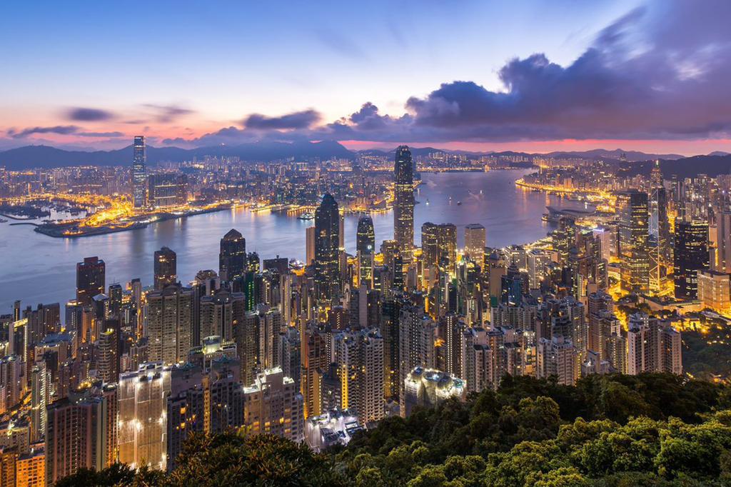 Hong Kong skyline at sunset with Victoria Harbour view.