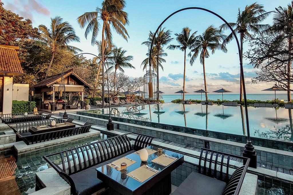 Infinity pool overlooking the ocean at a luxury beachfront resort. 